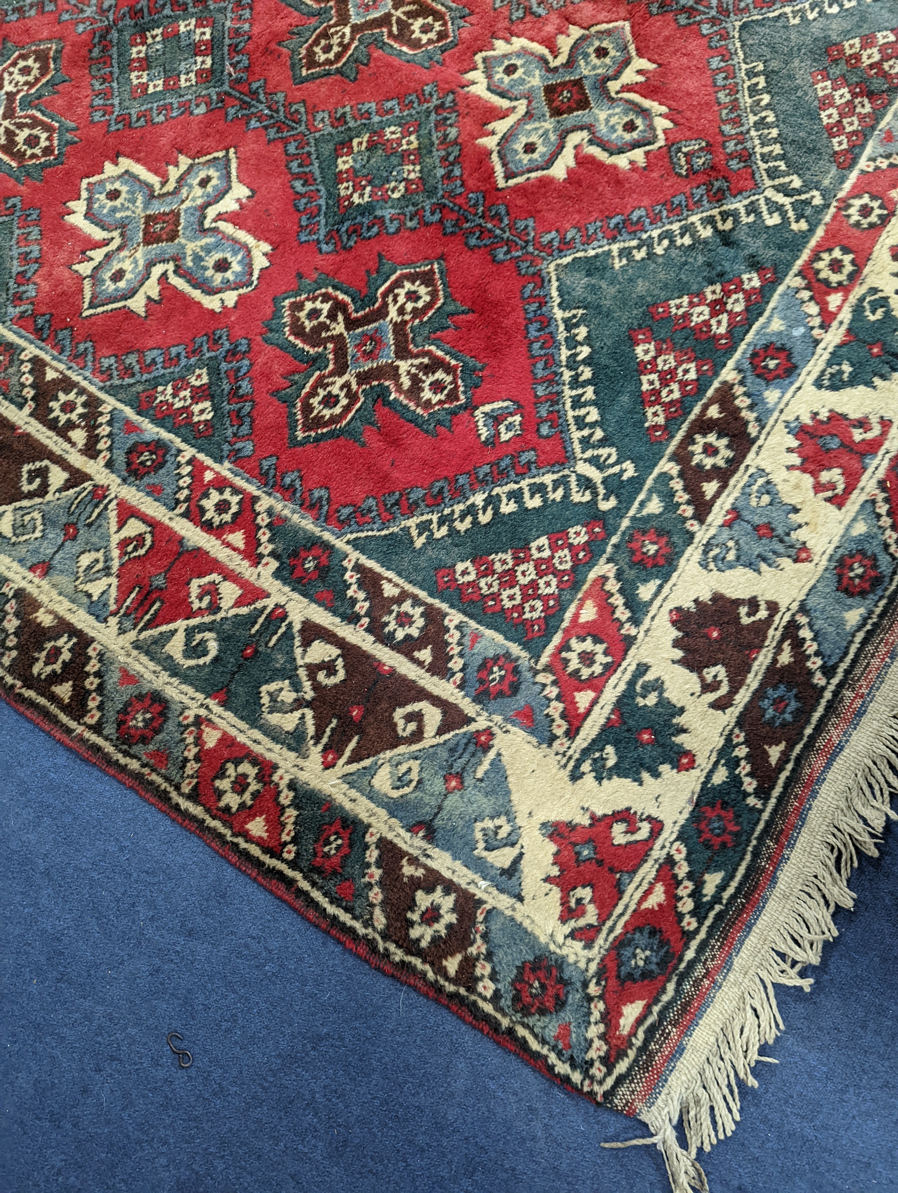 A Caucasian style red ground carpet, 286 x 210cm